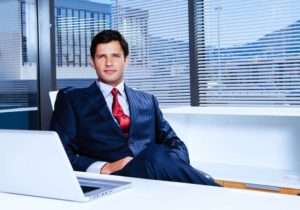 Investment banker sitting in front of a computer